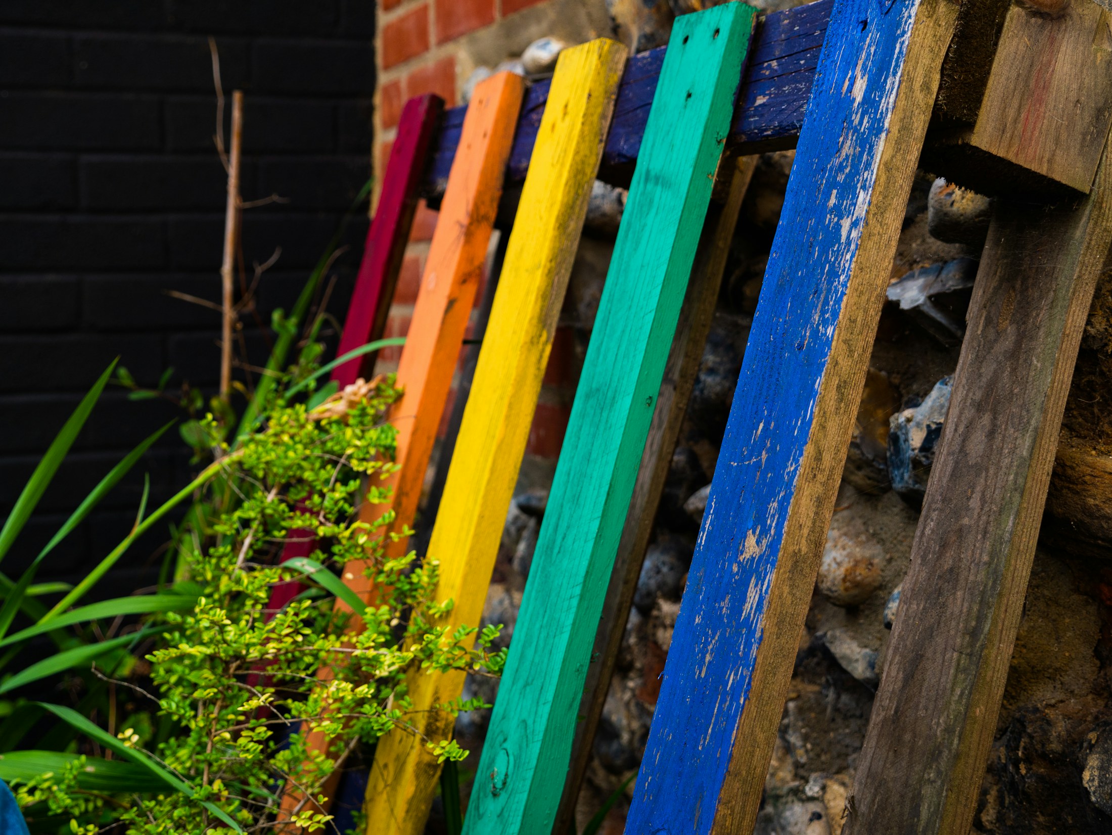 Colourful reclaimed pallet timber stacked together
